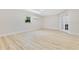 Spacious bedroom with light wood-look flooring, mini-split AC, and double doors at 2550 Barren Oak Ct, Deland, FL 32720