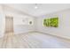 Bright bedroom with light wood-look floors and natural light from a large window at 2550 Barren Oak Ct, Deland, FL 32720
