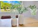 Dining room table adorned with decorative vases and an outdoor view through the window at 2550 Barren Oak Ct, Deland, FL 32720