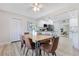 Dining area featuring a wood table with seating for six, wood floors and an open view to the kitchen at 2550 Barren Oak Ct, Deland, FL 32720