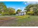 Two-story home with white siding and a spacious front yard surrounded by mature trees at 2550 Barren Oak Ct, Deland, FL 32720