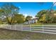 Charming two-story home with white picket fence and mature trees at 2550 Barren Oak Ct, Deland, FL 32720