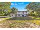Charming two-story home with white exterior, black trim, and a well-manicured front lawn at 2550 Barren Oak Ct, Deland, FL 32720