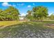 Spacious backyard featuring mature trees and lush greenery at 2550 Barren Oak Ct, Deland, FL 32720
