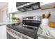 Close-up of a modern stainless steel oven and stove top with granite countertops at 2550 Barren Oak Ct, Deland, FL 32720
