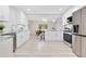 Bright, all-white kitchen with stainless steel appliances and an open view to the dining area at 2550 Barren Oak Ct, Deland, FL 32720