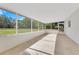 Large screened porch with views of surrounding trees and foliage at 2550 Barren Oak Ct, Deland, FL 32720