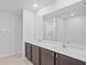 Bathroom featuring double sinks with quartz countertops and a large mirror at 269 Fig Ct, Kissimmee, FL 34759