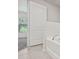 Bathroom featuring a white tub and a door leading to another room at 269 Fig Ct, Kissimmee, FL 34759