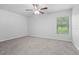 Bright bedroom featuring neutral carpet, a ceiling fan and a window at 269 Fig Ct, Kissimmee, FL 34759