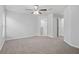 Spacious bedroom with neutral carpet, a ceiling fan and multiple doorways at 269 Fig Ct, Kissimmee, FL 34759