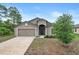 Charming single-story home with a two-car garage and well-maintained front yard at 269 Fig Ct, Kissimmee, FL 34759