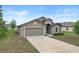 Well-maintained single-story home with neutral tones and a spacious driveway at 269 Fig Ct, Kissimmee, FL 34759