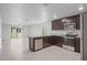 Modern kitchen featuring stainless steel appliances, granite countertops, and tiled floor at 269 Fig Ct, Kissimmee, FL 34759