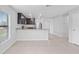Open-concept kitchen with stainless steel appliances, dark cabinets, granite countertops and tile flooring at 269 Fig Ct, Kissimmee, FL 34759