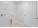 Bright laundry room with a metal shelf, tiled floor, connections, and a white painted door at 269 Fig Ct, Kissimmee, FL 34759