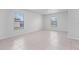 An empty tiled room with windows showcasing space and natural light at 269 Fig Ct, Kissimmee, FL 34759