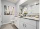 Bright bathroom featuring a double vanity with granite countertop and decorative accents at 2710 Golden Trout Ln, Edgewater, FL 32141