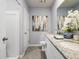 Bright bathroom with a double vanity featuring granite countertop and tiled floors at 2710 Golden Trout Ln, Edgewater, FL 32141