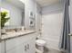 Well-lit bathroom featuring a vanity with granite countertop, a shower/tub, and gray tiled floors at 2710 Golden Trout Ln, Edgewater, FL 32141
