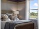 A bright bedroom features a scenic water view with natural light through the window at 2710 Golden Trout Ln, Edgewater, FL 32141