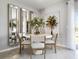 Cozy dining area featuring a round table, modern chairs, and decorative mirrors for a bright, inviting ambiance at 2710 Golden Trout Ln, Edgewater, FL 32141