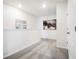 Well-lit hallway with neutral carpeting and white walls, accented with decorative artwork at 2710 Golden Trout Ln, Edgewater, FL 32141