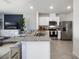 Open concept kitchen with granite countertops, stainless steel appliances, and barstool seating at 2710 Golden Trout Ln, Edgewater, FL 32141