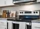 Modern kitchen appliance with stainless steel oven and cooktop, accompanied by countertop decor at 2710 Golden Trout Ln, Edgewater, FL 32141