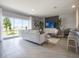 Inviting living room boasts natural light, tile flooring, backyard views, and modern furniture arrangement at 2710 Golden Trout Ln, Edgewater, FL 32141
