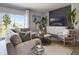 Comfortable living area features plush seating, natural light, stylish decor, and a serene view of the outdoors at 2710 Golden Trout Ln, Edgewater, FL 32141