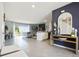 Spacious living area showcasing an open floor plan with tile floors, backyard view, and stylish decor at 2710 Golden Trout Ln, Edgewater, FL 32141