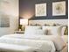 This main bedroom features decor art above the headboard and a lamp on the bedside table at 2710 Golden Trout Ln, Edgewater, FL 32141