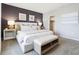Inviting main bedroom featuring a luxurious bed, side tables with lamps, and stylish wall decor at 2710 Golden Trout Ln, Edgewater, FL 32141