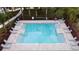Aerial view of a community swimming pool surrounded by lounge chairs and manicured lawns at 2710 Golden Trout Ln, Edgewater, FL 32141