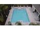 Overhead view of a community pool with lounge chairs, a cabana, and a safety fence at 2710 Golden Trout Ln, Edgewater, FL 32141
