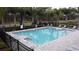 Community pool with lounge chairs, perimeter fence, and easy-access steps into the refreshing water at 2710 Golden Trout Ln, Edgewater, FL 32141