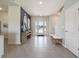 Bright foyer featuring tile flooring, modern decor, and a staircase at 2712 Golden Trout Ln, Edgewater, FL 32141