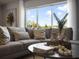 Cozy living room with a large window, comfortable couch, and stylish decor for a relaxing ambiance at 2712 Golden Trout Ln, Edgewater, FL 32141