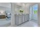 Bathroom features a large mirror, double vanity with granite countertop and white cabinets at 279 Wisteria Ct, Deltona, FL 32738