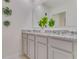 Bathroom features a double sink vanity with granite countertops, ample storage, and modern fixtures at 279 Wisteria Ct, Deltona, FL 32738
