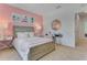 Bedroom with a pink accent wall, a cozy bed, decorative pillows, and a stylish desk area at 279 Wisteria Ct, Deltona, FL 32738