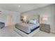 Bright bedroom featuring plush carpeting, a king-size bed, neutral walls, and ensuite bathroom access at 279 Wisteria Ct, Deltona, FL 32738