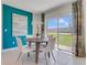 Bright breakfast nook with backyard view, modern table, and accent wall at 279 Wisteria Ct, Deltona, FL 32738