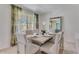 Beautifully staged dining room with neutral tones, modern furniture, and ample natural light at 279 Wisteria Ct, Deltona, FL 32738