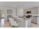 Open-concept kitchen featuring a large island, stainless steel appliances, and neutral-toned cabinetry at 279 Wisteria Ct, Deltona, FL 32738
