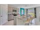 Kitchen with a large central island with bar seating and stainless steel appliances at 279 Wisteria Ct, Deltona, FL 32738