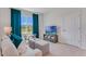 Bright living room featuring a sofa, teal accents, a TV, and natural light at 279 Wisteria Ct, Deltona, FL 32738