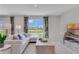 Bright living room with large windows, modern furniture, and a comfortable seating area at 279 Wisteria Ct, Deltona, FL 32738