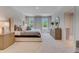 Spacious main bedroom with large windows, plush carpeting, and stylish furniture at 279 Wisteria Ct, Deltona, FL 32738